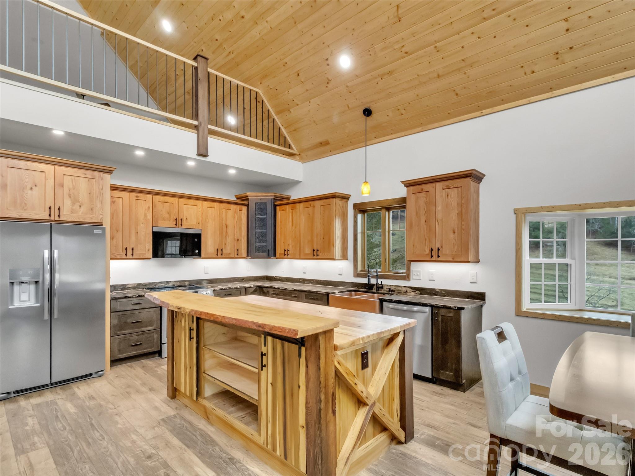171 Cowtail Cove Clyde, NC 28721 - Photo 6 of 48 a kitchen with stainless steel appliances granite countertop a sink a stove and a refrigerator