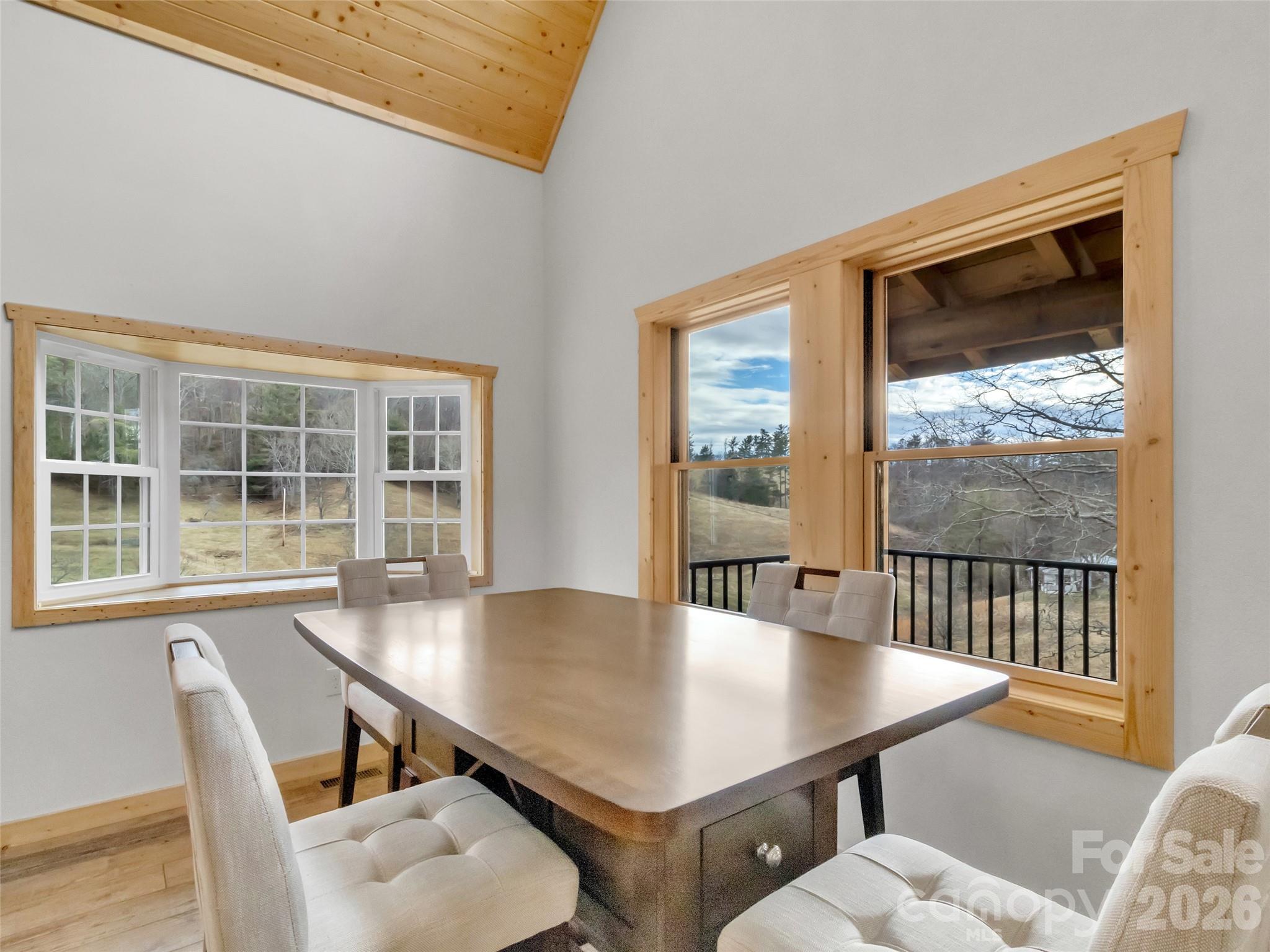 171 Cowtail Cove Clyde, NC 28721 - Photo 10 of 48 a view of a dining room with furniture window and wooden floor