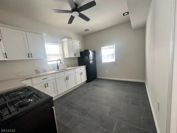 a kitchen with a sink stove and cabinets