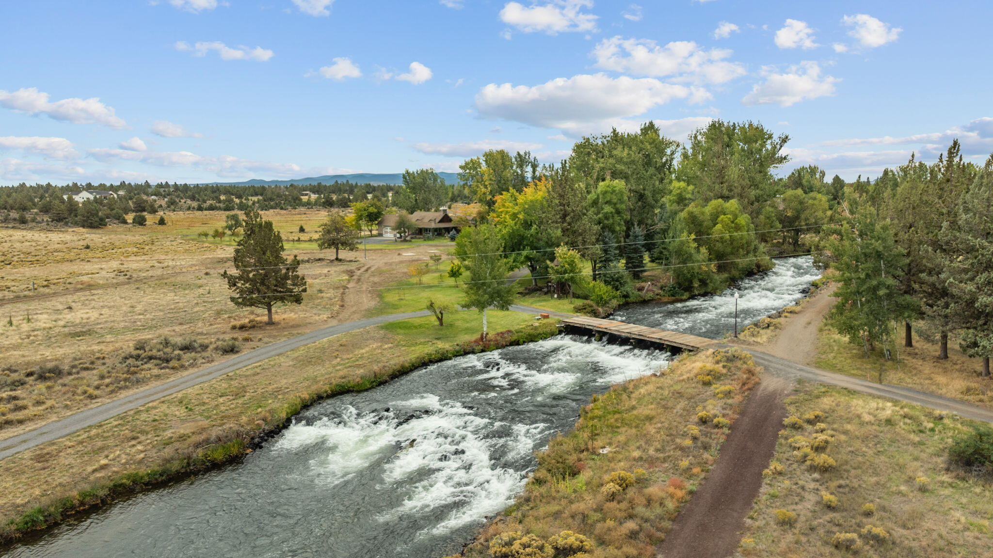 21925 Bear Creek Road Bend, OR 97702 - Photo 100 of 104 a view of a lake with a yard