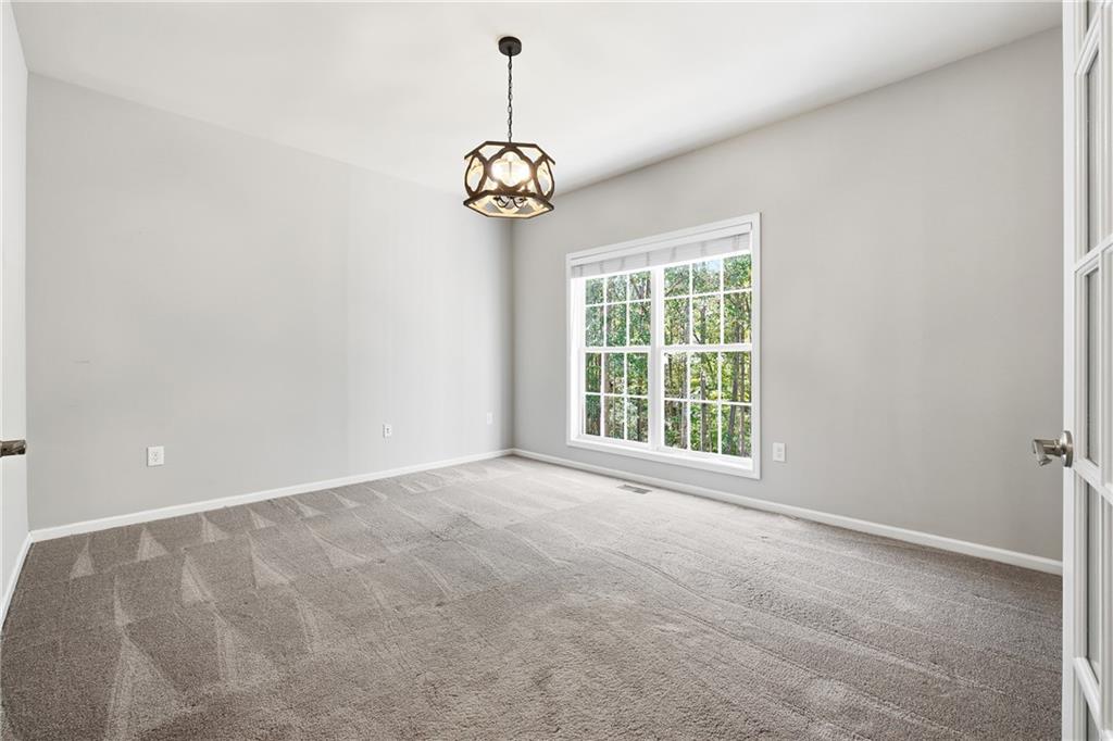 304 Meadowcrest Circle Canton, GA 30115 - Photo 17 of 50 a view of an empty room with a window and a ceiling fan