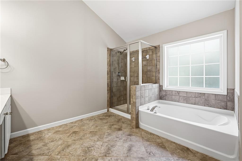 304 Meadowcrest Circle Canton, GA 30115 - Photo 21 of 50 a bathroom with a bathtub and a shower