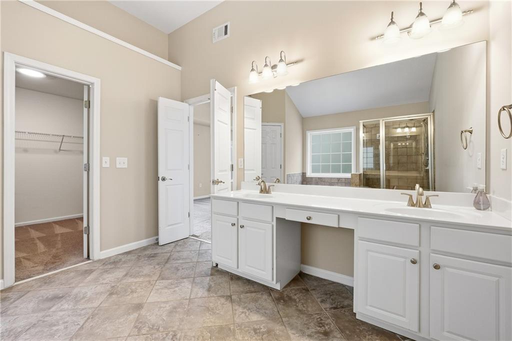 304 Meadowcrest Circle Canton, GA 30115 - Photo 22 of 50 a spacious bathroom with a sink a mirror and a shower