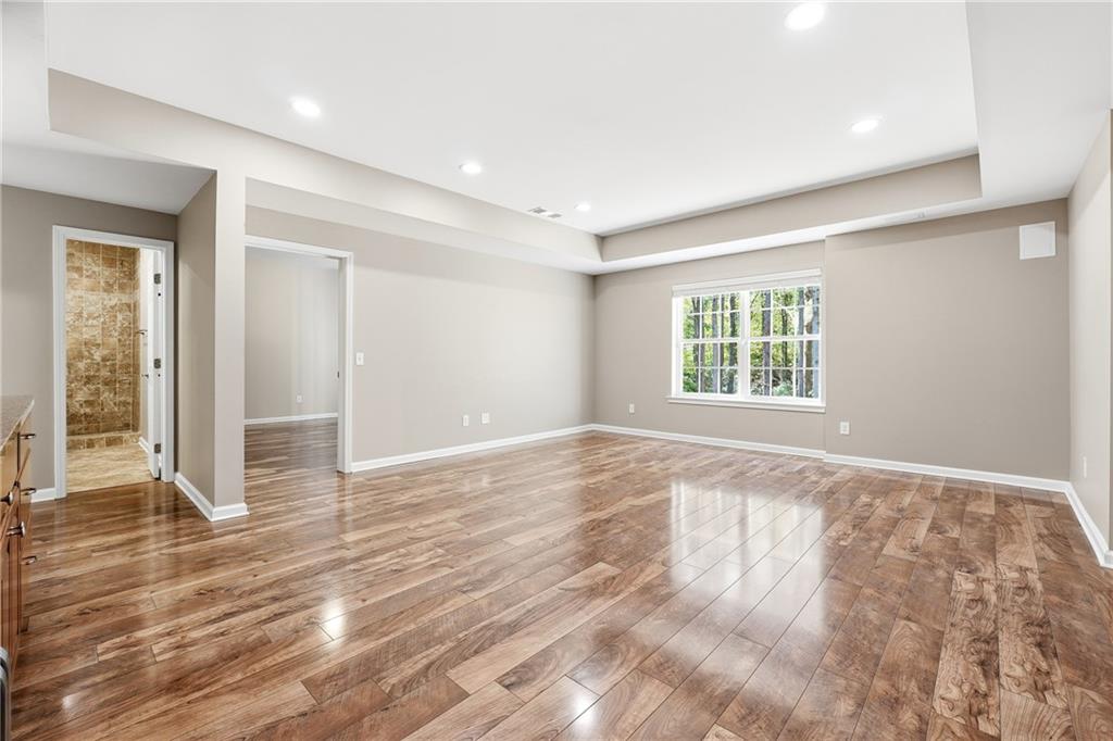 304 Meadowcrest Circle Canton, GA 30115 - Photo 29 of 50 an empty room with wooden floor and windows