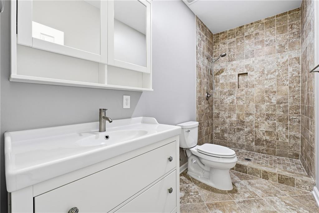 304 Meadowcrest Circle Canton, GA 30115 - Photo 31 of 50 a bathroom with a sink a toilet and shower