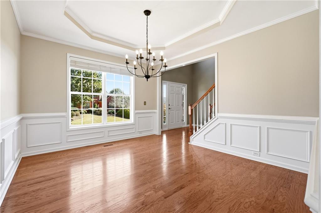 304 Meadowcrest Circle Canton, GA 30115 - Photo 7 of 50 a view of an empty room with wooden floor and a window