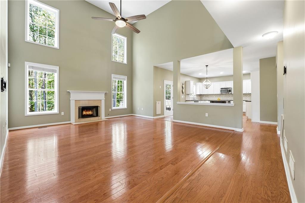 304 Meadowcrest Circle Canton, GA 30115 - Photo 10 of 50 a view of a kitchen with a stove wooden cabinets and wooden floor