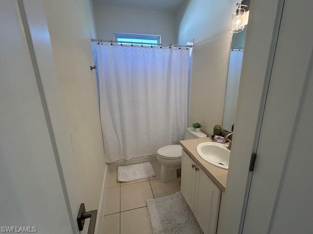 430 Crossfield Circle Naples, FL 34104 - Photo 18 of 24 a bathroom with a sink a toilet a mirror and shower curtain