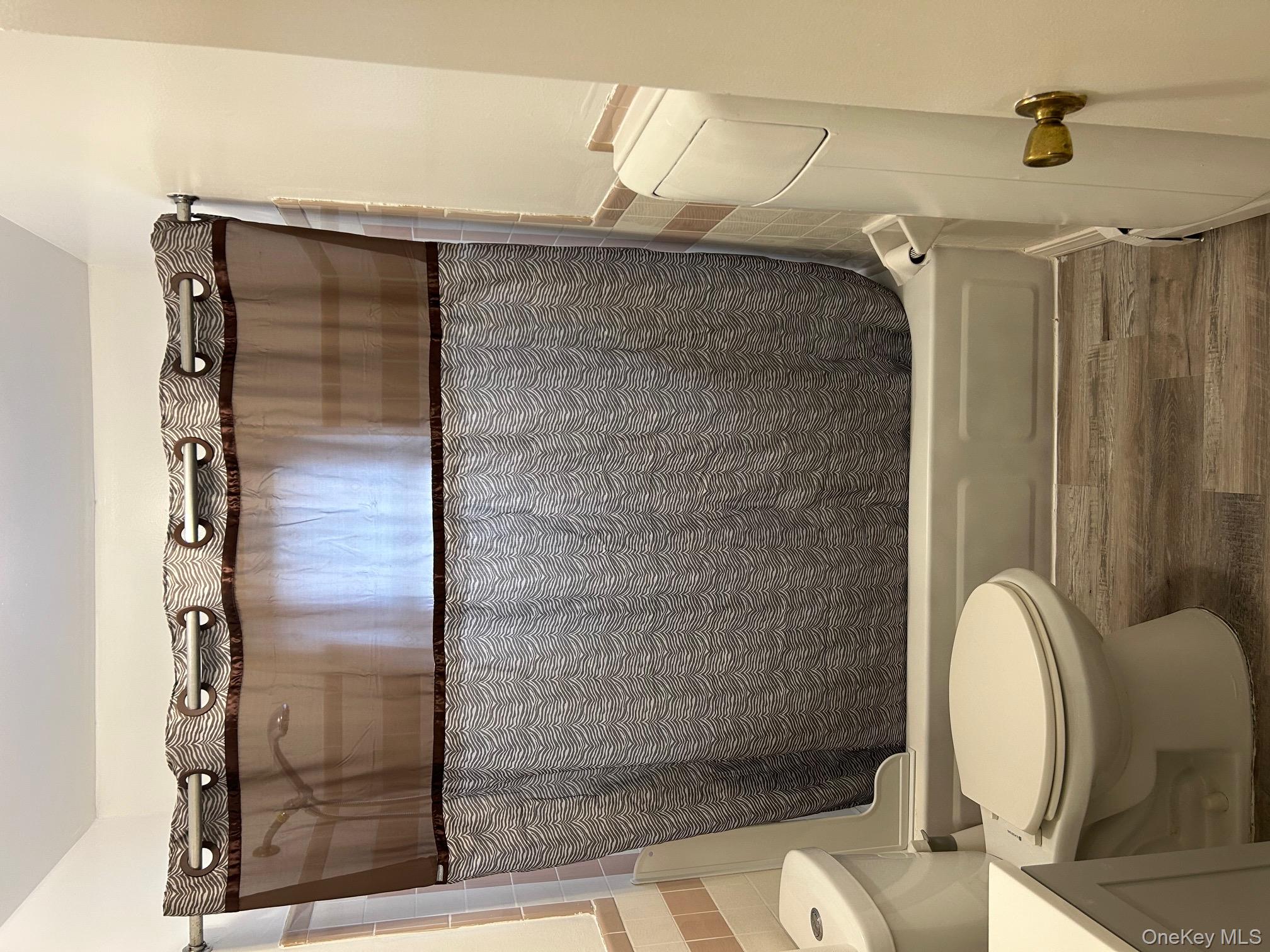 122 Sneden Place West, Unit 122 Spring Valley, NY 10977 - Photo 16 of 20 Bathroom featuring dark wood-style floors, shower / tub combo, and vanity