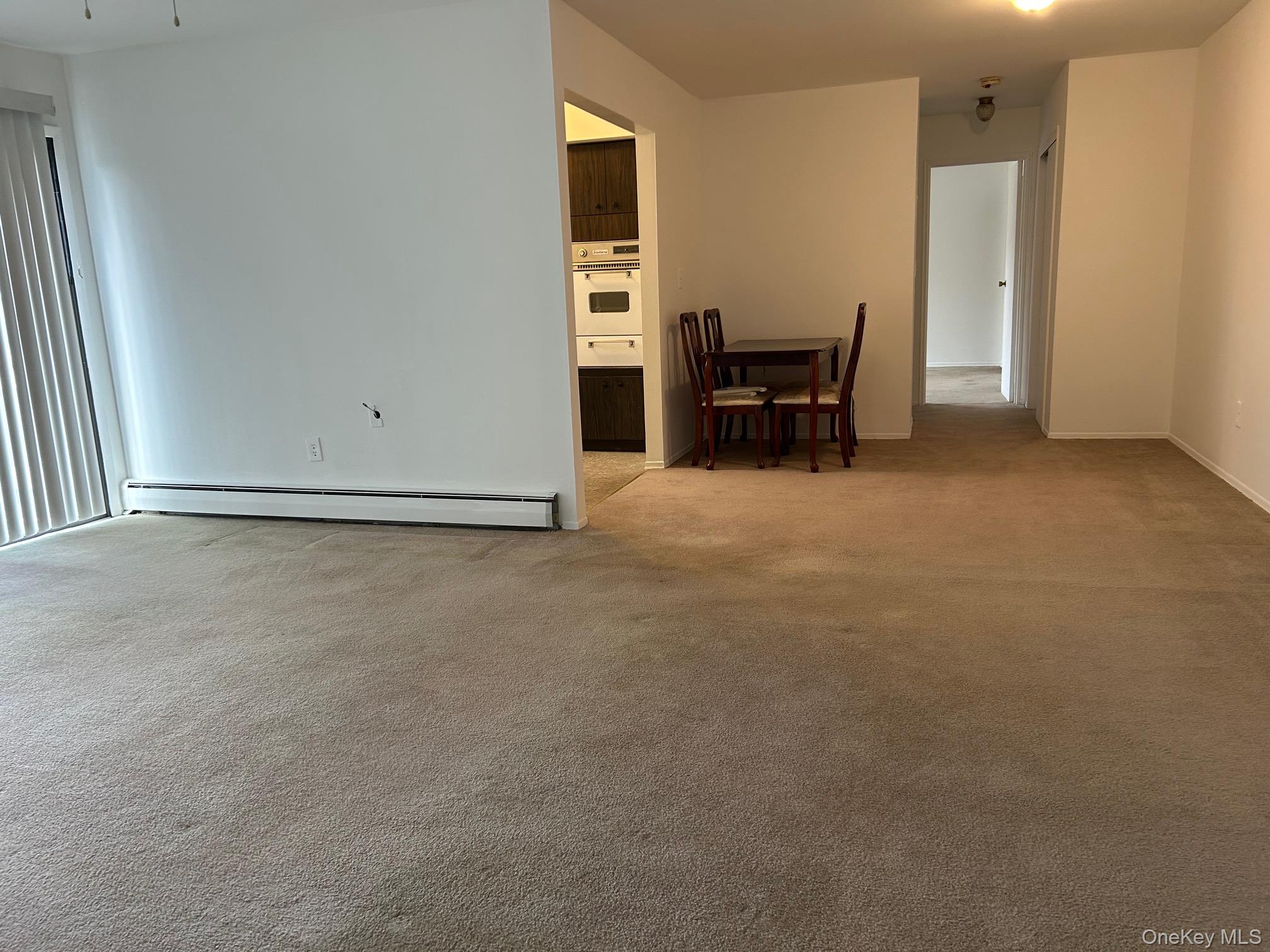 122 Sneden Place West, Unit 122 Spring Valley, NY 10977 - Photo 3 of 20 Spare room with light colored carpet and baseboard heating