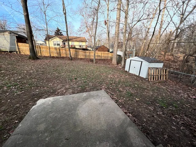 a backyard of a house with table and chairs
