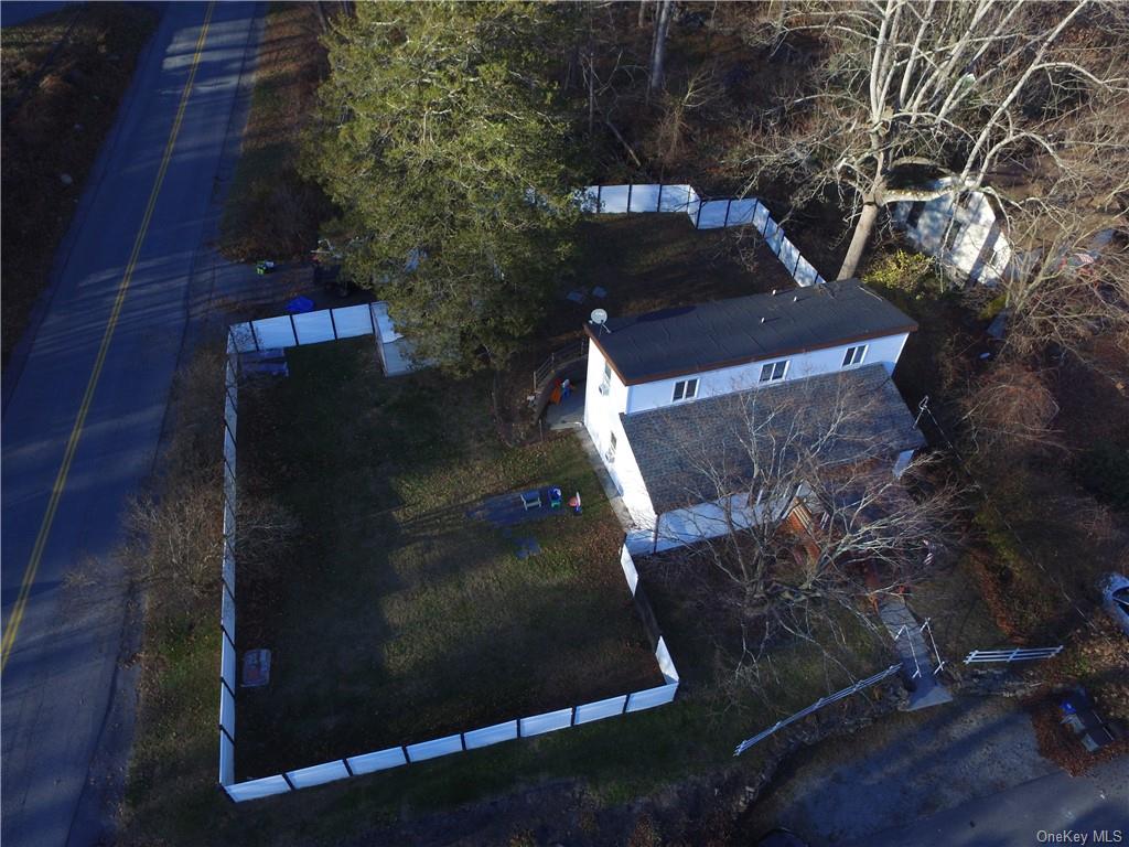 A peak from above! Nicely fenced in corner lot with two areas for parking.