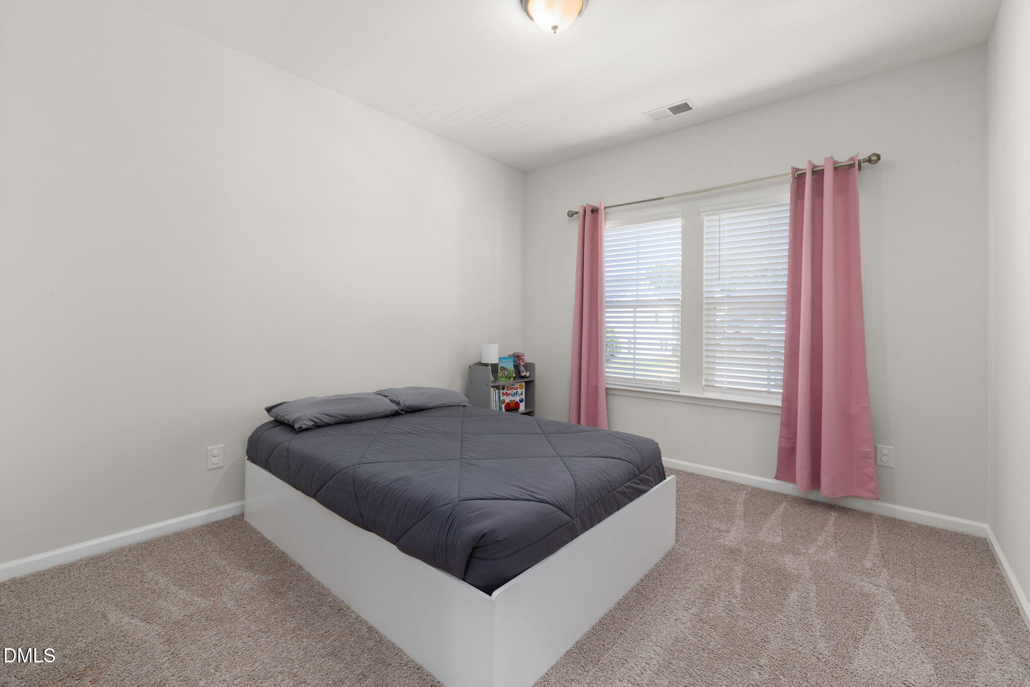 3422 Longleaf Estates Drive Raleigh, NC 27616 - Photo 41 of 71 a bed sitting in a bedroom next to a window