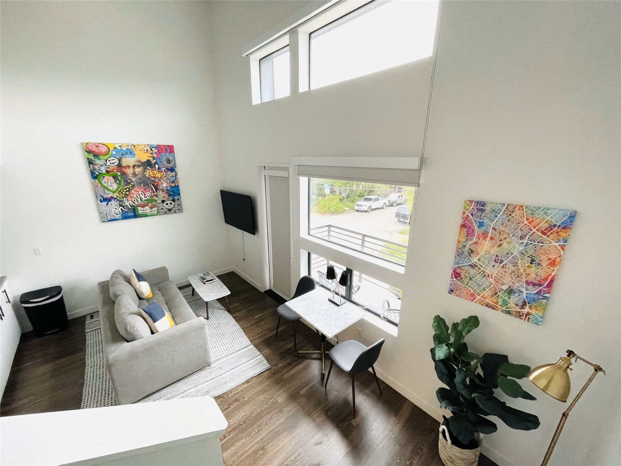 49 Navasota Street, Unit 201 Austin, TX 78702 - Photo 5 of 13 Living area featuring dark wood-style flooring and a high ceiling