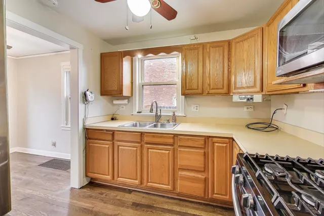 a kitchen with a sink stove top oven and cabinets