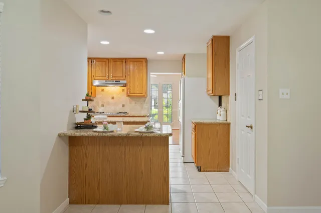 a view of a livingroom with wooden floor and kitchen space with a sink