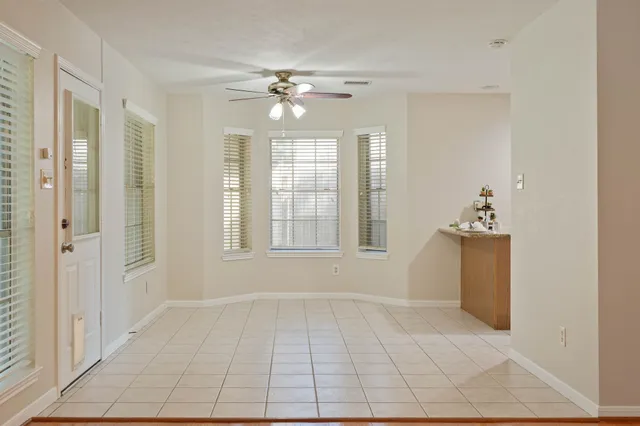a view of an empty room with a fireplace and a window