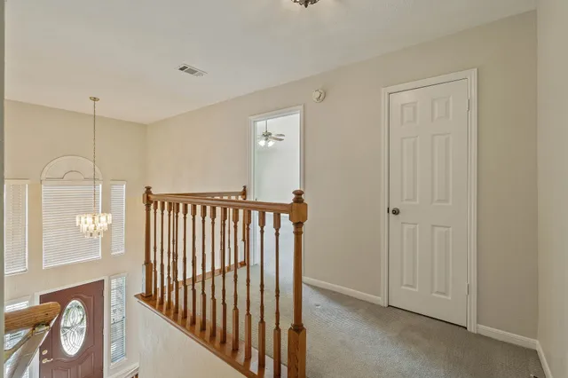 an empty room with closet and a ceiling fan