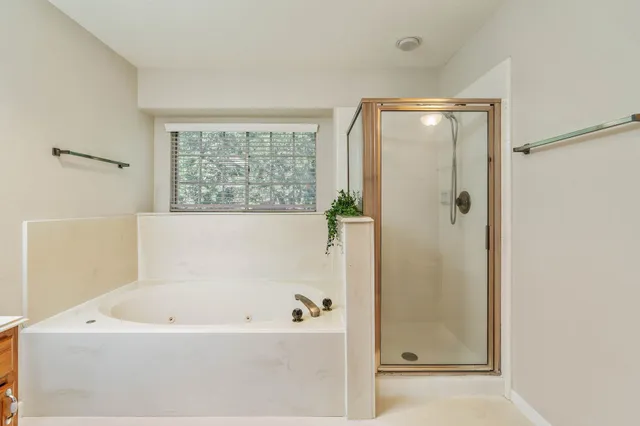 a bathroom with a granite countertop sink a mirror and a bathtub