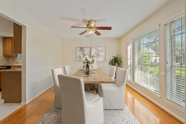 a dining room with furniture a chandelier and wooden floor
