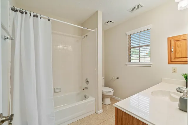 a bathroom with a double vanity sink and mirror with shower