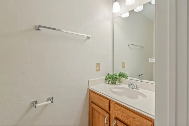 an empty room with closet and a chandelier fan