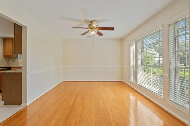 a view of a room with a window and a ceiling fan
