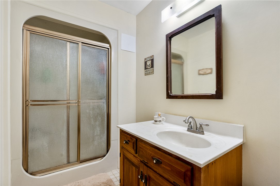 801 Princeton Highway Honea Path, SC 29654 - Photo 18 of 49 This bright bathroom features a vanity with a white countertop and a convenient shower.