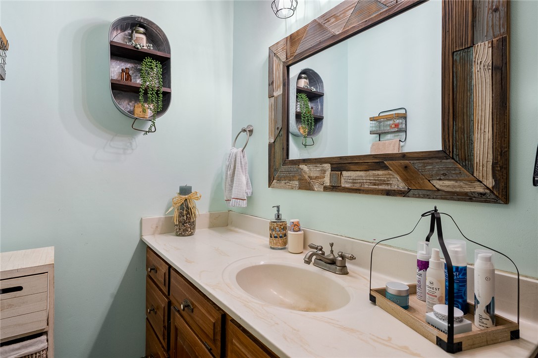 801 Princeton Highway Honea Path, SC 29654 - Photo 23 of 49 This bright bathroom features a spacious vanity and a rustic-framed mirror, offering both style and utility.