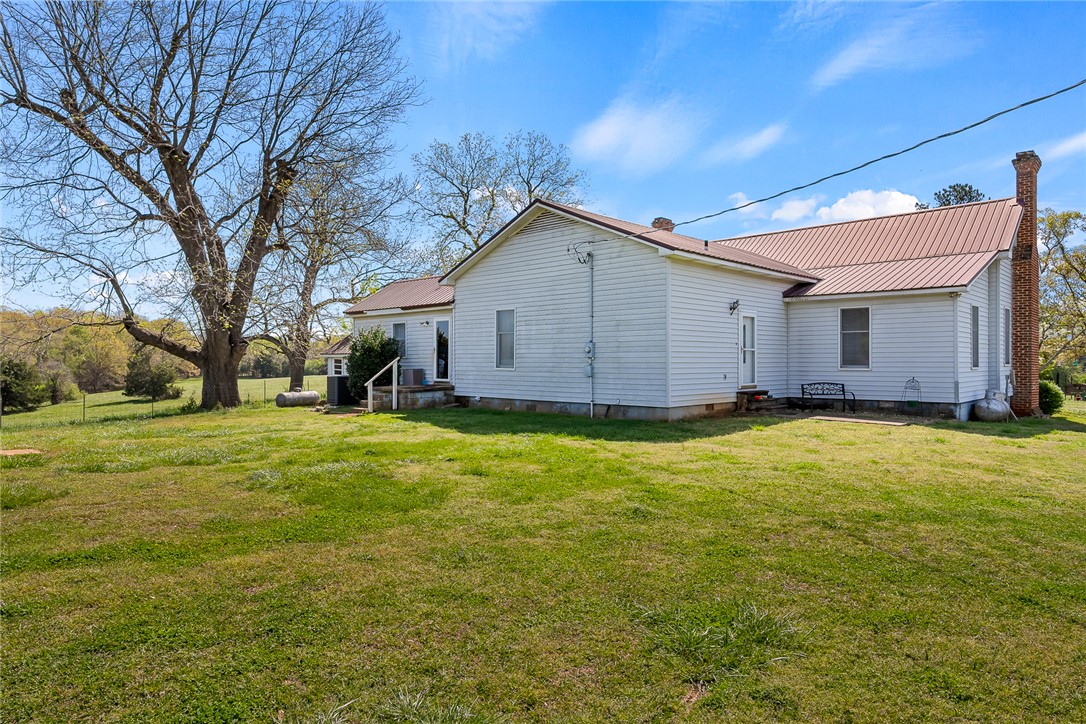 801 Princeton Highway Honea Path, SC 29654 - Photo 26 of 49 This classic white siding home features a durable metal roof and a spacious yard, offering quiet country living.