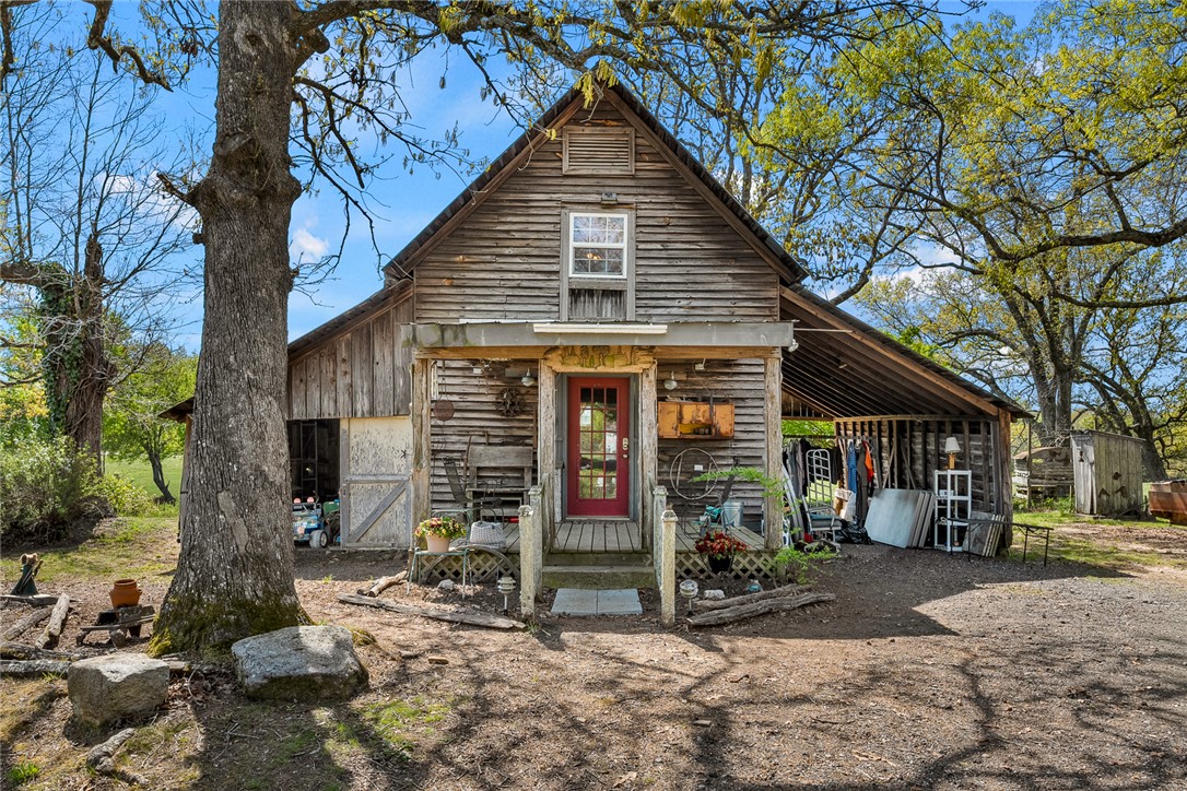 801 Princeton Highway Honea Path, SC 29654 - Photo 27 of 49 This rustic wood-sided home features a charming red door and an inviting covered front porch.
