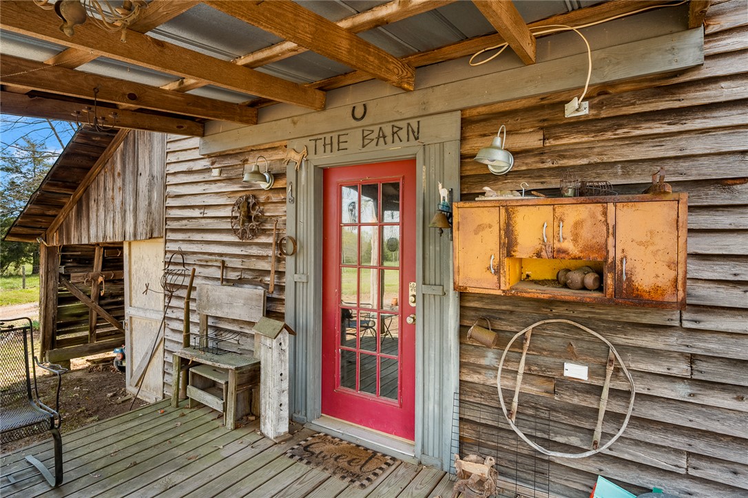 801 Princeton Highway Honea Path, SC 29654 - Photo 29 of 49 Rustic charm greets you at the entrance of this unique barn structure, featuring classic wood siding.