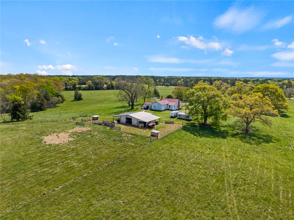 801 Princeton Highway Honea Path, SC 29654 - Photo 42 of 49 Expansive green acreage surrounds a charming rural residence with additional structures.