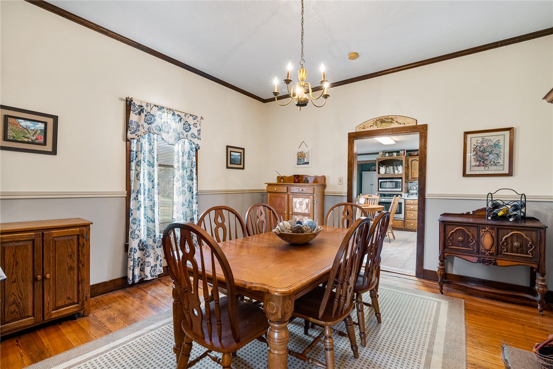801 Princeton Highway Honea Path, SC 29654 - Photo 8 of 49 This inviting dining room features classic wood floors and an elegant chandelier, perfect for intimate gatherings.