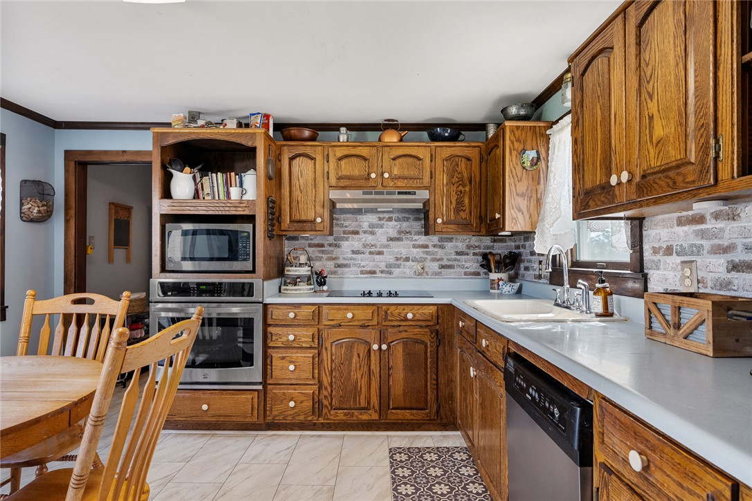 801 Princeton Highway Honea Path, SC 29654 - Photo 10 of 49 This warm kitchen features robust cabinetry and practical amenities for daily living.