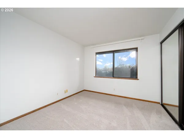 a view of an empty room with glass door