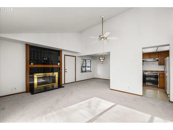 a view of an empty room with a kitchen