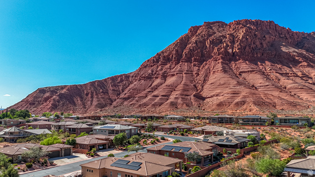 322 340 E Street Ivins, UT 84738 - Photo 61 of 61 Residential community nestled at the base of a prominent red rock formation, featuring contemporary residences with varying rooflines