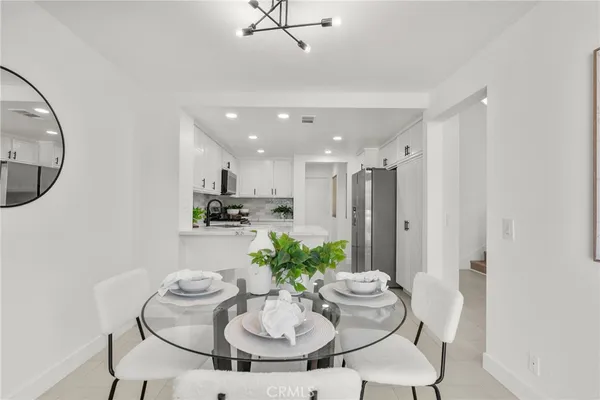 a dining room with furniture and a potted plant