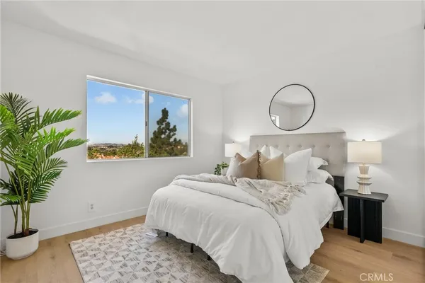 a bedroom with bed and a potted plant