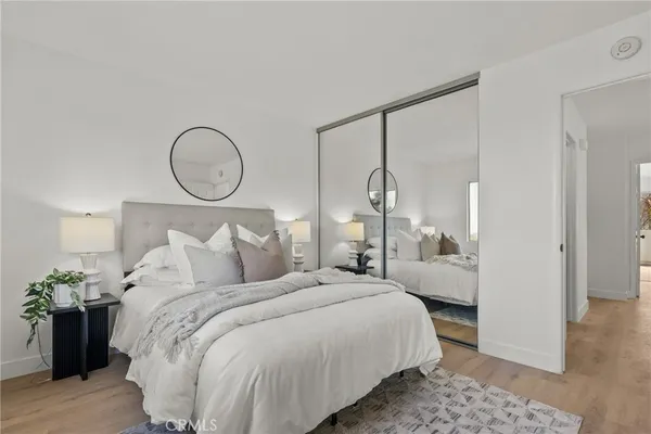 a bedroom with bed and a chandelier