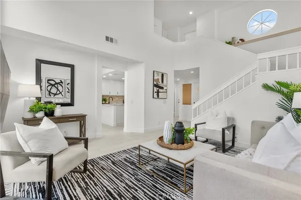 a bedroom with furniture and a potted plant