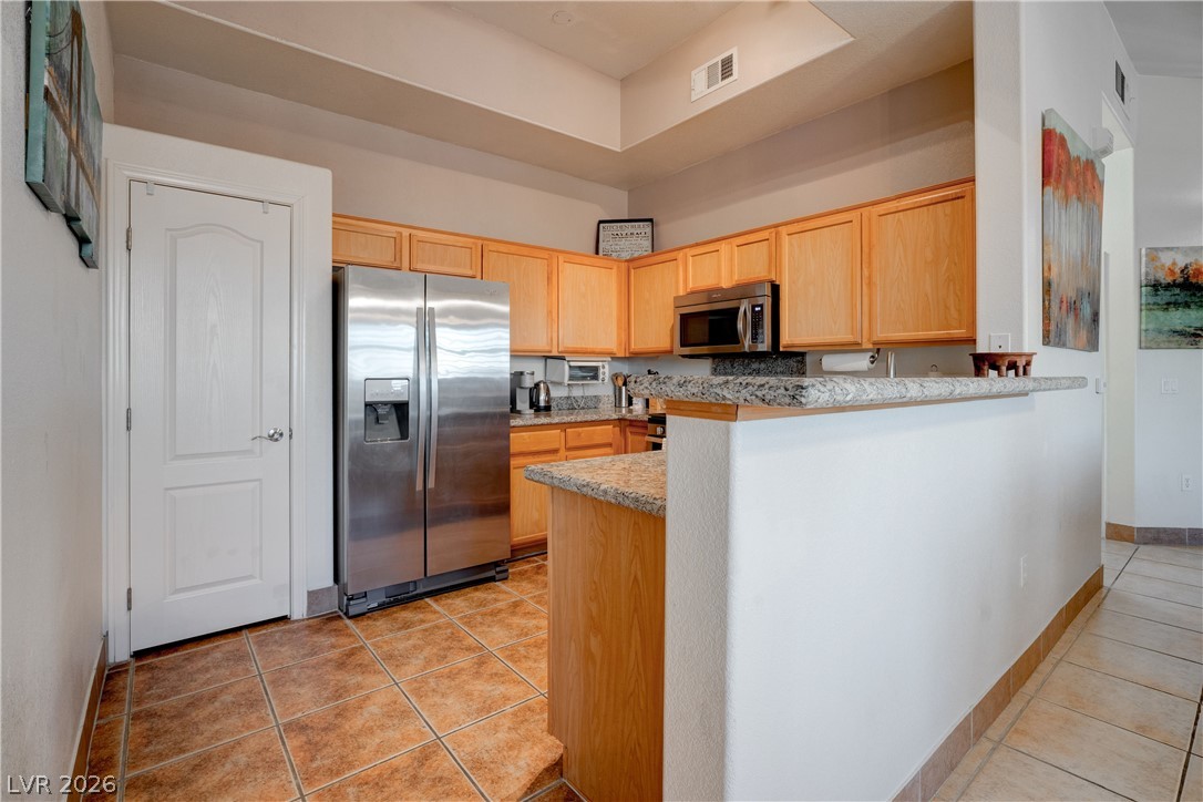 2305 West Horizon Ridge Parkway, Unit 224 Henderson, NV 89052 - Photo 18 of 41 This spacious kitchen features tile flooring and modern stainless steel appliances.