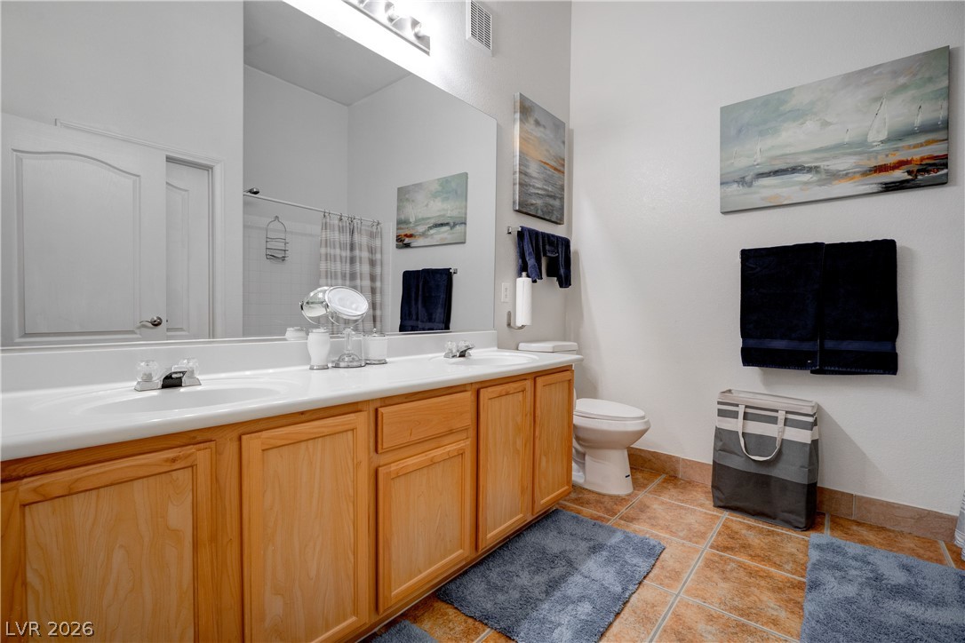 2305 West Horizon Ridge Parkway, Unit 224 Henderson, NV 89052 - Photo 26 of 41 This spacious bathroom offers dual vanities and tiled flooring, perfect for daily routines.