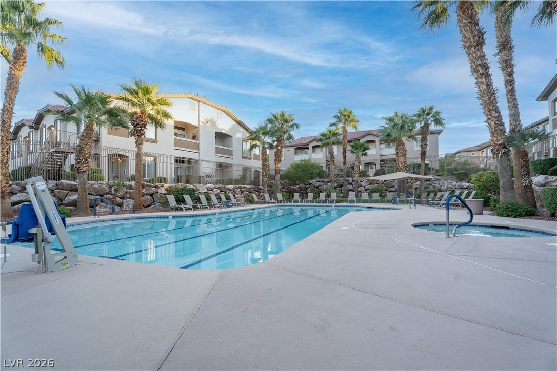 2305 West Horizon Ridge Parkway, Unit 224 Henderson, NV 89052 - Photo 39 of 41 This inviting community pool and spa offers a refreshing escape, surrounded by lush palm trees.