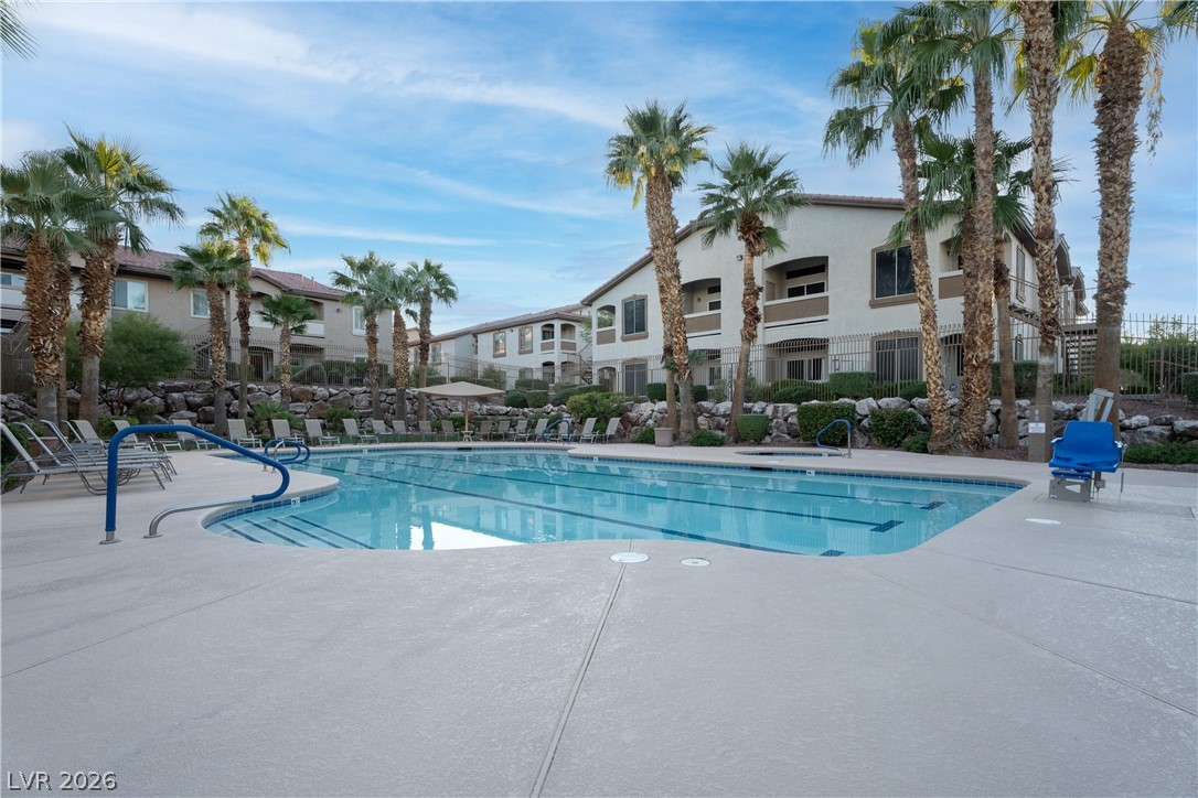 2305 West Horizon Ridge Parkway, Unit 224 Henderson, NV 89052 - Photo 40 of 41 Relax and unwind in the sparkling pool, surrounded by lush landscaping and residential views.
