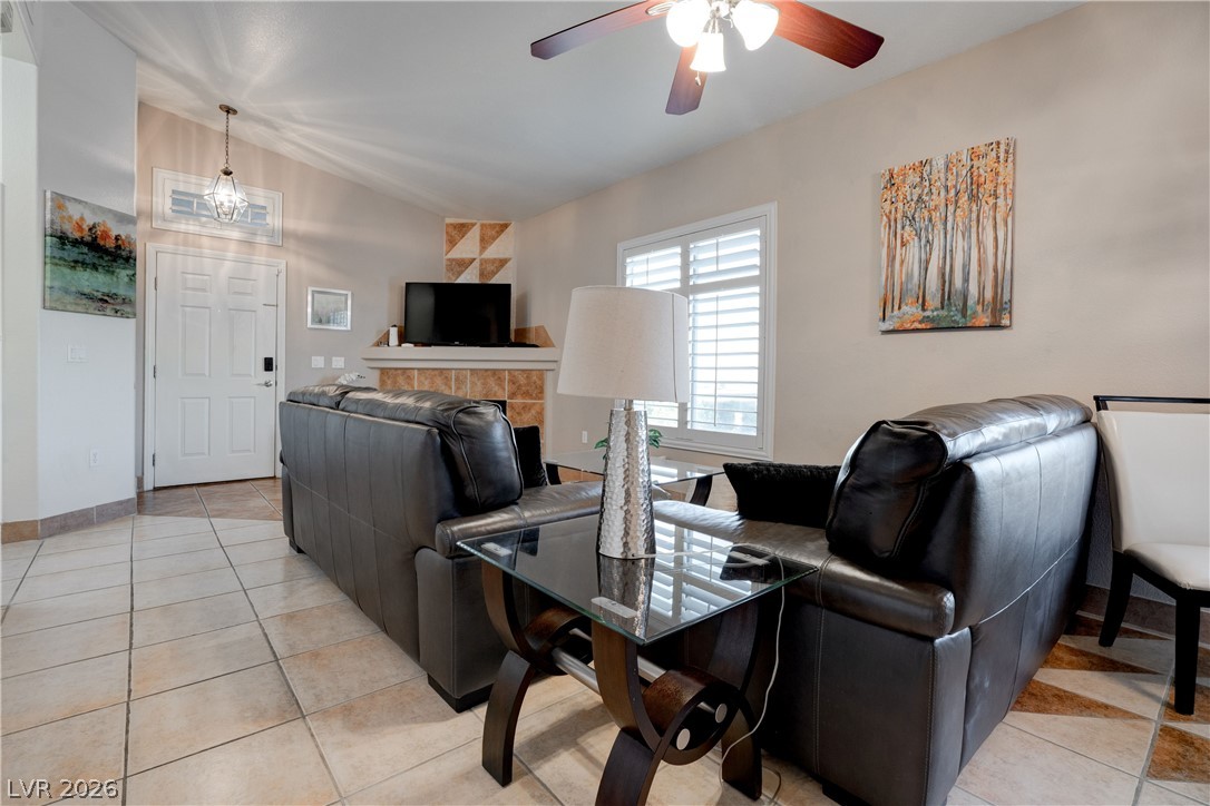 2305 West Horizon Ridge Parkway, Unit 224 Henderson, NV 89052 - Photo 10 of 41 This inviting living room features a ceiling fan, a fireplace, and elegant tiled flooring.