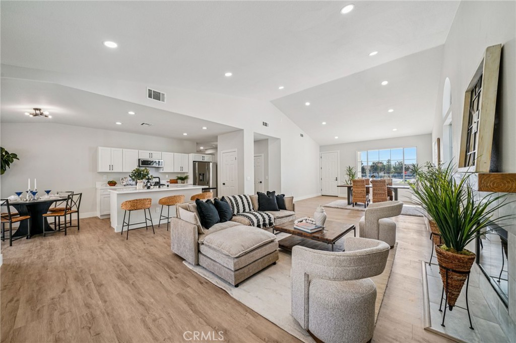 12842 Tilden Drive Rancho Cucamonga, CA 91739 - Photo 13 of 71 a living room with furniture a dining table and kitchen view with wooden floor