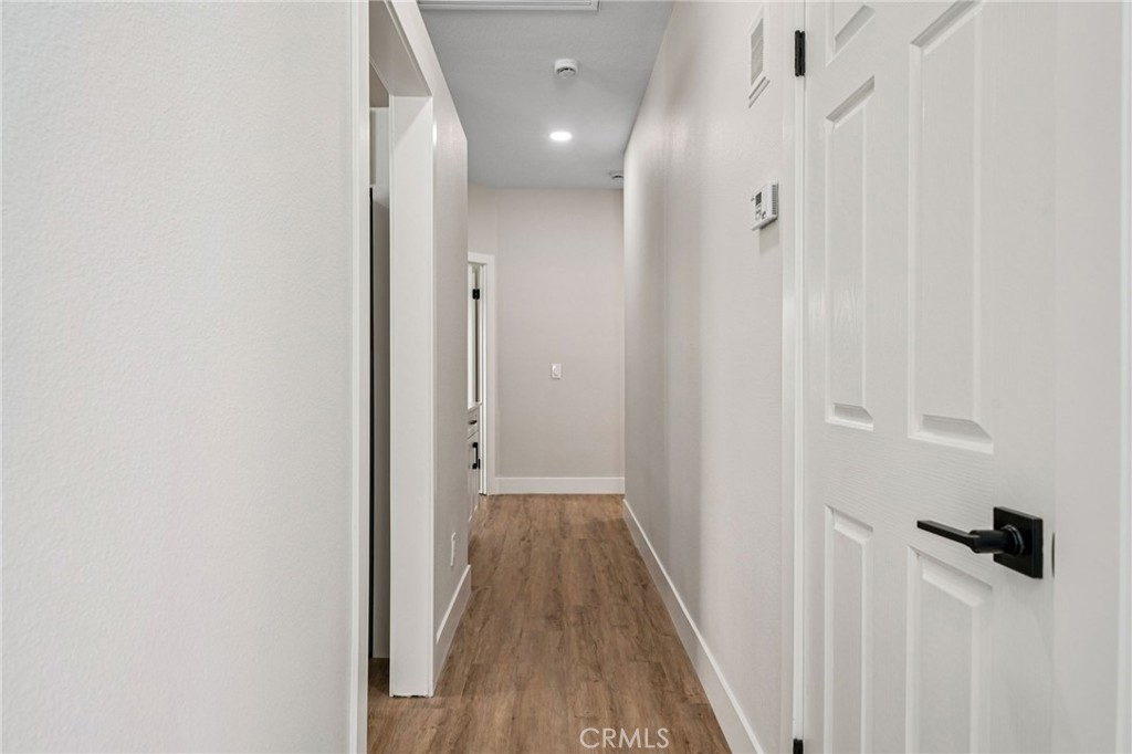 12842 Tilden Drive Rancho Cucamonga, CA 91739 - Photo 21 of 71 a view of a hallway with wooden floor