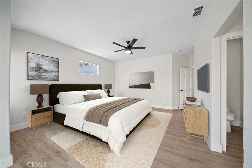 12842 Tilden Drive Rancho Cucamonga, CA 91739 - Photo 24 of 71 a spacious bedroom with a bed and a chandelier